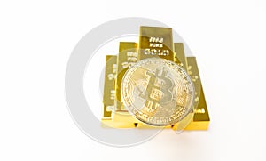 Bitcoin laying on stacked gold bars gold ingots rendered with shallow depth of field. Bitcoin as desirable as gold concept