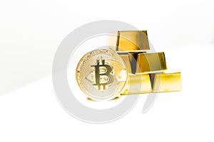 Bitcoin laying on stacked gold bars gold ingots rendered with shallow depth of field. Bitcoin as desirable as gold concept