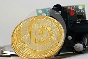 Bitcoin leaning on circuit board