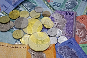 Bitcoin and Malaysian ringgit banknotes background