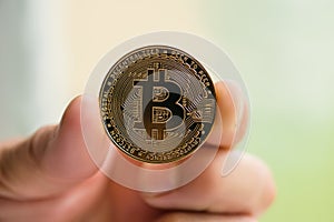 Bitcoin in man hand close up