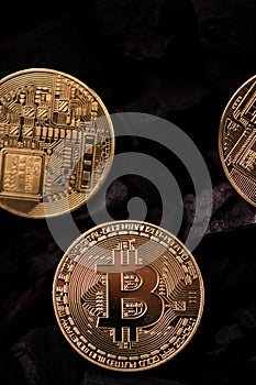 Bitcoin mining concept. Bitcoin cuurency on charcoal