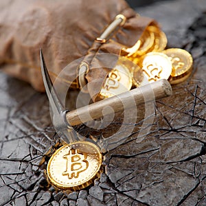Bitcoin mining concept with pickaxe and leather bag