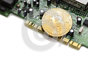 Bitcoin mining process - gold coin on computer circuit board with bitcoin processor and microchips. Electronic currency, internet