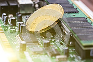 Bitcoin mining process - gold coin on computer circuit board with bitcoin processor and microchips. Electronic currency, internet