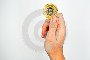 Bitcoin: The new virtual money / Close Up shot of Hand holdling one golden Bitcoin: Business, Money and Technology Concept