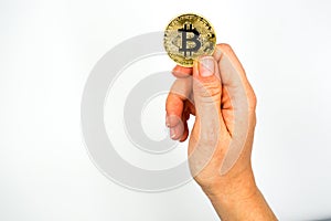 Bitcoin: The new virtual money / Close Up shot of Hand holdling one golden Bitcoin: Business, Money and Technology Concept