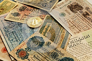 Bitcoin with old deutsch money. Cash Inflation. Cryptocurrency concept background. Closeup with copy space.