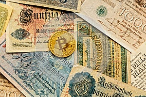 Bitcoin with old deutsch money. Inflation. Cryptocurrency concept background. Closeup with copy space.