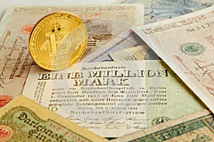 Bitcoin with old deutsch money. Inflation of paper money. Cryptocurrency concept background. Closeup with copy space.