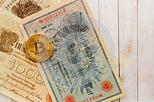 Bitcoin with old deutsch money. Inflation of paper money. Cryptocurrency concept background. Closeup with copy space.