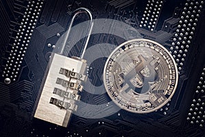 Bitcoin with padlock on computer motherboard. Crypto currency Internet data privacy information security concept.