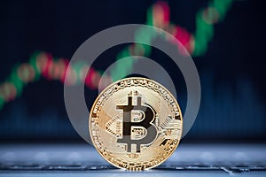 Bitcoin physical coin symbol on laptop with uptrend price graph background, future concept financial currency