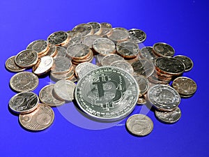 Bitcoin on a pile of Euro cents