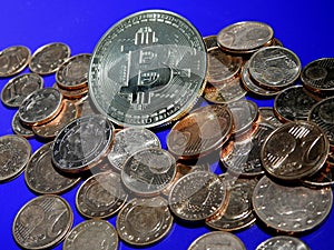 Bitcoin on a pile of Euro cents