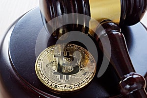 Bitcoin Regulation. BTC crypto coin and gavel on a desk.