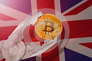 Bitcoin regulation in United Kingdom UK; bitcoin btc coin being squeezed in vice on United Kingdom flag background