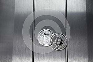 Bitcoin silver crypto coin lies on the metalic surface