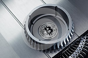 Bitcoin silver crypto coin lies on the metalic surface