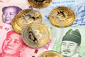 Bitcoin on South Korea Won and China Yuan Renminbi money.