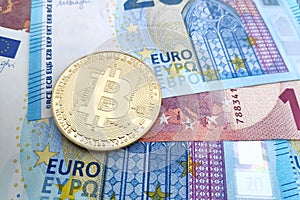Bitcoin on a stack of Euro banknotes