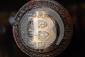 Bitcoin Symbol on a Round Golden Emblem Surrounded by Zeroes and Ones