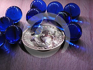 Bitcoin with ten blue glass marbles.