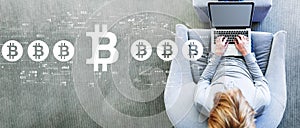 Bitcoin theme with man using a laptop