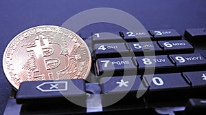 Bitcoin on top of computer number keyboard part
