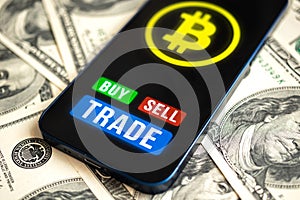 Bitcoin trading concept. Mobile phone application for cryptocurrency. Buy and sell new virtual money. Money dollars