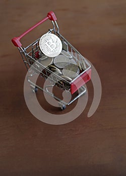 Bitcoin in a trolley with money photo