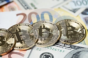 Bitcoin on two hundred euro banknote and 100 dollar bills. Exchange crypto currency with euro and dollar concept, trading digital