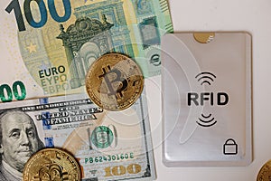 Bitcoin US dollar, euro and Credit card with protective RFID case. NFC contactless payment cards. Cyber cryme