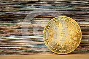 Bitcoin value, Cryptocurrency wallet, financial concept, Golden bitcoin standing on the background of a stack of banknotes