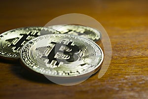 Bitcoin - virtual coins grouped with wooden background