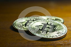 Bitcoin - virtual coins grouped with wooden background