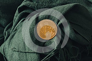 bitcoin virtual currency on green fabric