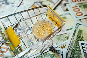 Bitcoin vs Dollars Shopping Cart Background of Hundreds of Dollars Green Yellow.