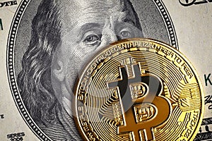 Bitcoin vs US dollar, gold bit coin on 100 dollar bill