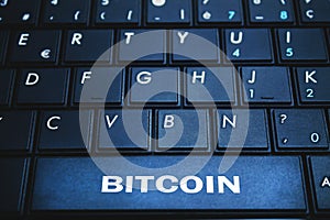 Bitcoin word on the computer keyboard. Blockchain concept.