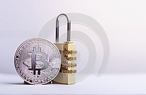 BitcoinBTC coin with padlock lying on white background.  Bitcoin security.