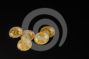 Bitcoins coins on black background