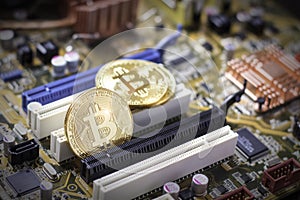 Bitcoins on the computer motherboard. Mining cryptocurrency