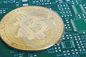 Bitcoins on green circuit board background closeup