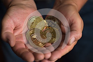 Bitcoins in man hands closeup