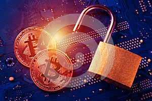 Bitcoins with opened padlock on computer motherboard. Crypto currency Internet data privacy information security concept.
