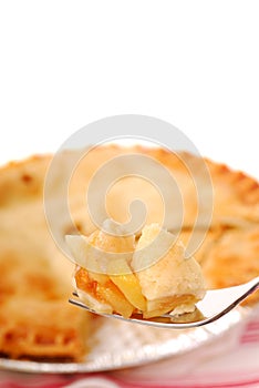 Bite of apple pie on a fork