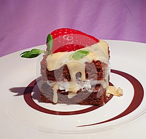 A bite of brownie with stawberrie,melted white chocolate ,stuffed with mascarpone on a pastel background.