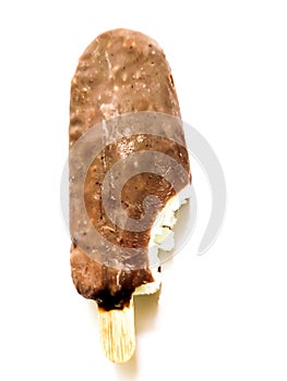 Bite ice cream covered by brown chocolate isolated on white background