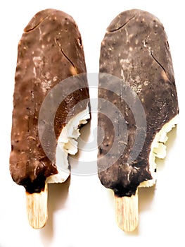 Bite ice cream covered by brown chocolate  on white background